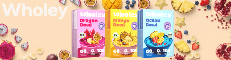 Drei Wholey Smoothie-Bowl-Packungen in Dragon, Mango und Ocean Geschmacksrichtungen mit frischen Früchten